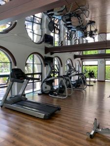 a gym with treadmills and ellipticals in a room at La Casita Luxus Condo Hua Hin in Hua Hin