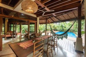 a dining room with a hammock and a pool at Alaia Hideaway in General Luna