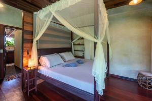 a bed with a canopy in a room at Alaia Hideaway in General Luna