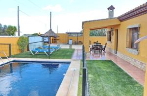 a house with a swimming pool in a yard at Casa Calas Boliña in Roche