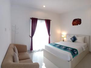 Letto o letti in una camera di Gaing Mas Residence By Gaing Mas Group