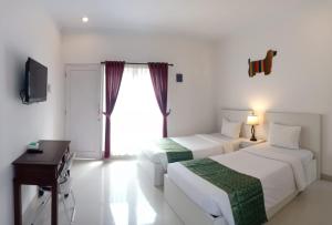 Letto o letti in una camera di Gaing Mas Residence By Gaing Mas Group