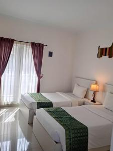 Letto o letti in una camera di Gaing Mas Residence By Gaing Mas Group