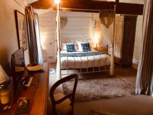 a bedroom with a bed and a chair in a room at Domaine de l’Escuderia in Parentis-en-Born