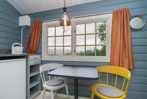 a kitchen with a table and chairs and a window at Ljoshaugen Camping in Dombås
