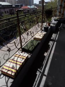 a row of benches sitting on a balcony at Arm Hostel in Yerevan