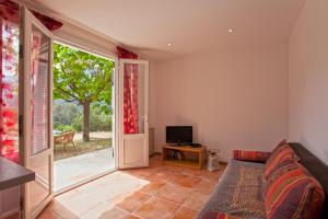 a bedroom with a bed and a tv and a door at Villa Kalliste in Porto Ota