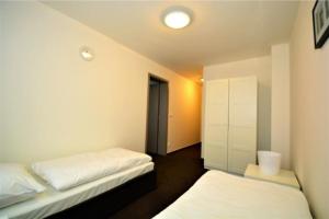 a room with two beds and a hallway at Hotel Harfa in Prague