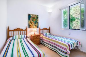 Łóżko lub łóżka w pokoju w obiekcie Villa Mar Gran