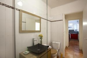 a bathroom with a sink and a toilet and a mirror at Villa Kalliste in Porto Ota +57 photos