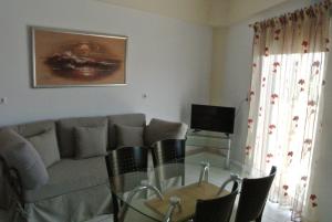 a living room with a glass table and a couch at central square HOUSE kokalaki in Kefalos