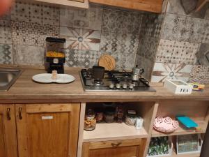 a kitchen with a stove and a counter top at Family House in Lecce +49 photos