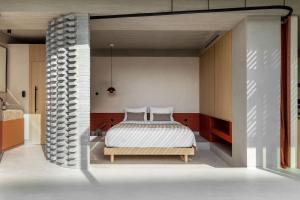 a bedroom with a bed and a brick wall at The Newel Psychiko in Athens