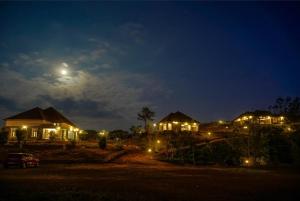 a house at night with the moon in the sky at Green Veil Cottages in Pīrmed
