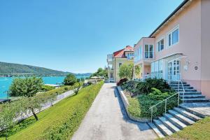 a house with stairs next to the water at Appartements Schwarzvilla in Velden am Wörthersee