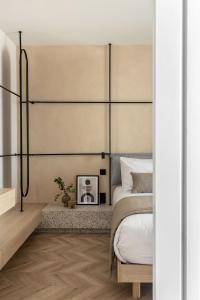 a bedroom with a bed with a large headboard at The Newel Psychiko in Athens