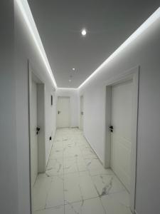 an empty hallway with white walls and white doors at Villa Denis Ksamil in Ksamil