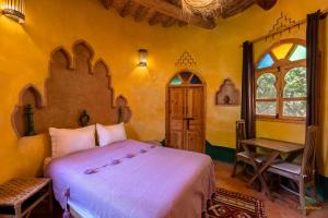 Postel nebo postele na pokoji v ubytování Ecolodge La Palmeraie