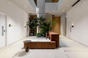 a lobby with a table and potted plants at The Newel Psychiko in Athens