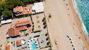 an overhead view of a beach with umbrellas and the ocean at Malgrat de Mar Beachfront Village in Malgrat de Mar