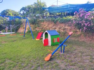 a group of childrens playground equipment in a yard at Armeno Studios in Limenaria