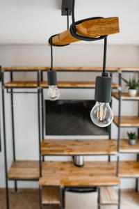 a chandelier hanging over a table with a tv at Pensjonat Pod Brzozami in Ustronie Morskie