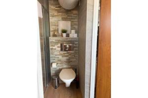 a small bathroom with a toilet in a hallway at Royal Blue przy samym Morzu Plaży in Primorsko