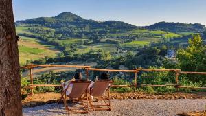 two people sitting in chairs looking at a valley at Stelle di Monte in Montepulciano