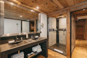 a bathroom with a sink and a shower at Les Suites – Maison Bouvier in Tignes +27 photos