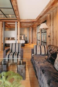 a living room with two couches and a table at Les Suites – Maison Bouvier in Tignes