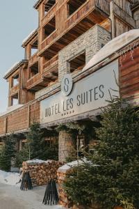 a hotel les suites sign in front of a building at Les Suites – Maison Bouvier in Tignes