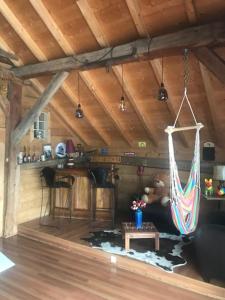 a room with a hammock hanging from the ceiling at Chalet 1830 au pied du MONT CHARVIN in La Savatte