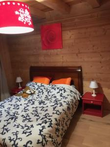 a bedroom with a bed and two tables with lamps at Chalet 1830 au pied du MONT CHARVIN in La Savatte