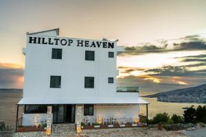 a building with a sign that readsullaipop heaven at Hilltop Heaven Hotel in Sarandë