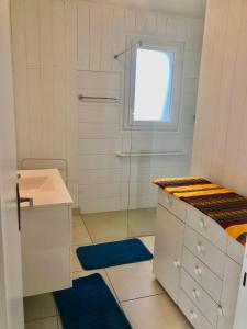 een witte badkamer met een wastafel en een douche bij Maison centre Bretagne in Langonnet