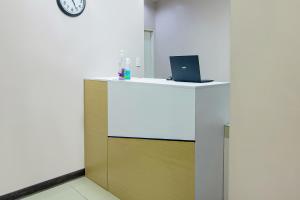 an office with a desk with a laptop on it at OYO 766 Ichehan Apartments in Manila