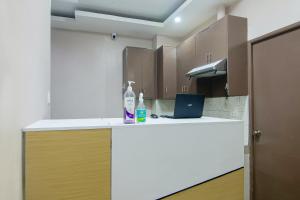 a kitchen with a counter with a laptop on it at OYO 766 Ichehan Apartments in Manila