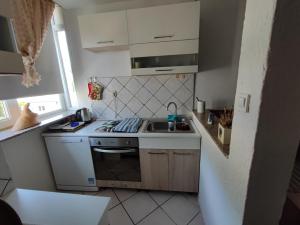 a small kitchen with a stove and a sink at Apartment Matea in Senj