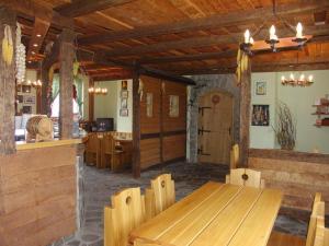 a dining room with a wooden table and chairs at Penzión Réva in Turna nad Bodvou
