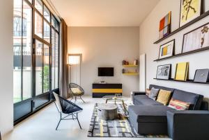 a living room with a couch and a table at Sweet Inn - Brune in Paris