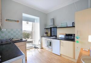a kitchen with a sink and a stove at All Day View. in North Berwick