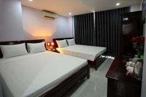 Krevet ili kreveti u jedinici u objektu Nhatrang Cozy Hotel