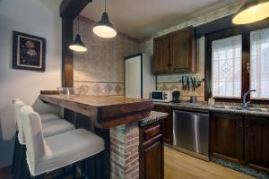 a kitchen with wooden cabinets and a counter top at Villa Carmen in Ronda