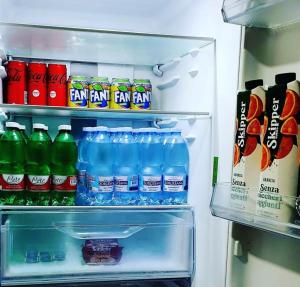 an open refrigerator filled with bottles of water and soda at SPARTA in Ercolano
