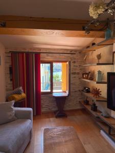 a living room with a couch and a window at Fenêtre sur Collioure in Collioure