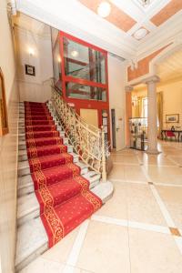 a staircase in a building with a red carpet at Hotel Pallanza in Verbania