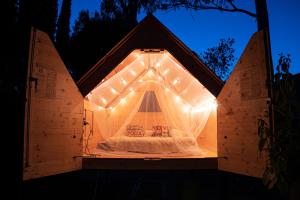 Bett in einem Zimmer mit 2 Surfbrettern in der Unterkunft Casa Dei Prati Camping Village in Lacona