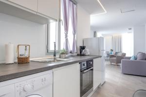 a kitchen with a sink and a counter top at Sea Breeze Apartments in Cala Millor