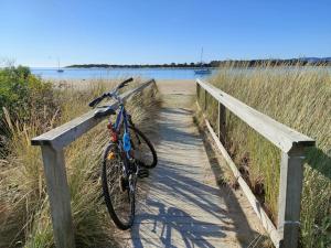 a bike parked on a wooden bridge near the water at CHILL in Port Sorell