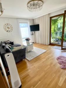 a living room with a couch and a table at Apartament Nadmorski Dwór- Gdańsk in Gdańsk